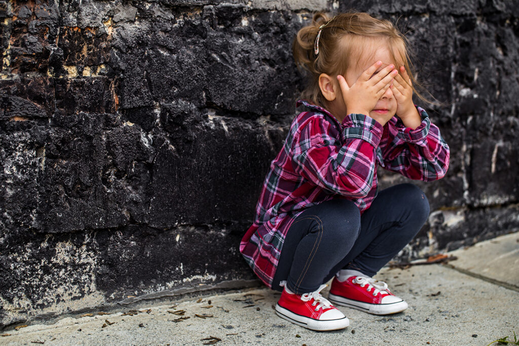 little-beautiful-girl-near-brick-wall