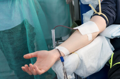close-up-arm-of-a-man-who-donates-blood-male-donor-gives-blood-in-a-mobile-blood-donation-center-donation-to-support-during-a-pandemia-of-coronavirus-selective-focus